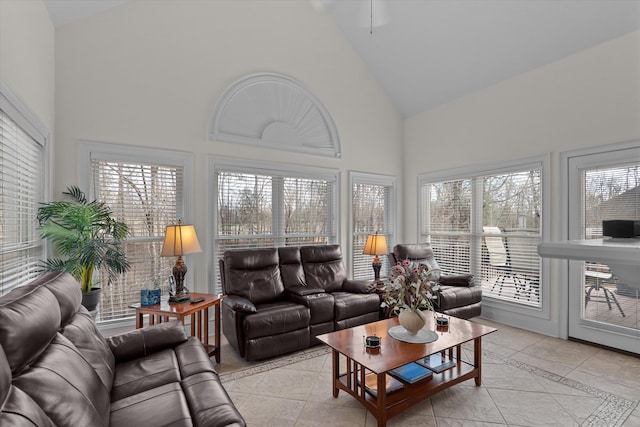 living area featuring high vaulted ceiling and light tile patterned flooring