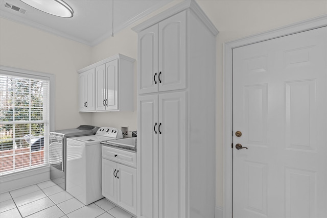 washroom featuring visible vents, light tile patterned flooring, cabinet space, ornamental molding, and washer and dryer