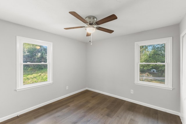 unfurnished room featuring ceiling fan, baseboards, and dark wood-style flooring