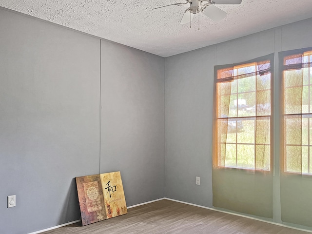 4112 Quail Farm Rd, Thomson, GA 30824 - spare room with a textured ceiling, ceiling fan, baseboards, and wood finished floors