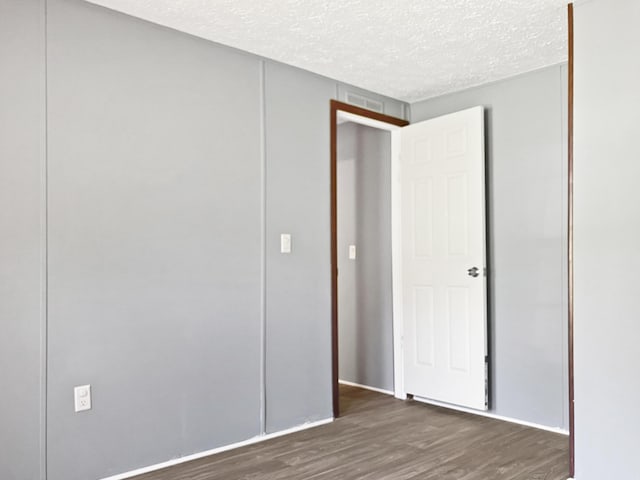 4112 Quail Farm Rd, Thomson, GA 30824 - unfurnished bedroom featuring baseboards, a textured ceiling, and wood finished floors
