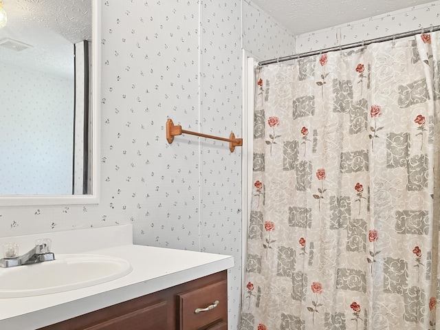 4112 Quail Farm Rd, Thomson, GA 30824 - bathroom with vanity, visible vents, curtained shower, wallpapered walls, and a textured ceiling