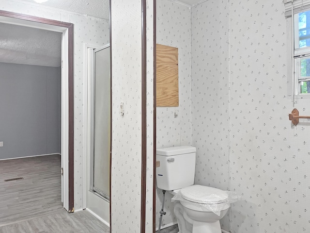 4112 Quail Farm Rd, Thomson, GA 30824 - bathroom with a textured ceiling, visible vents, wood finished floors, and a stall shower
