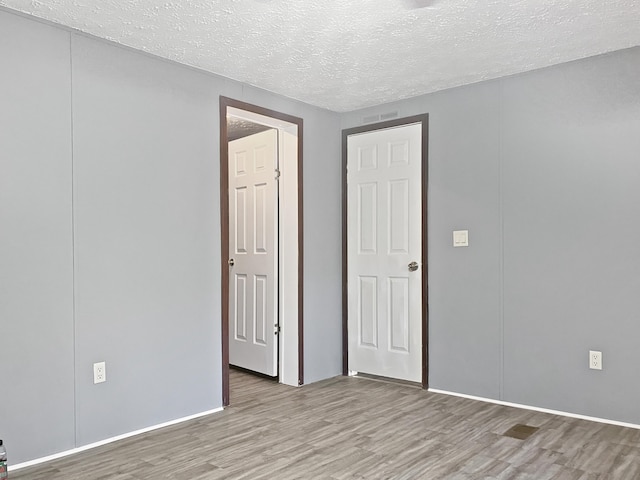 4112 Quail Farm Rd, Thomson, GA 30824 - interior space featuring baseboards, light wood-style flooring, and a textured ceiling