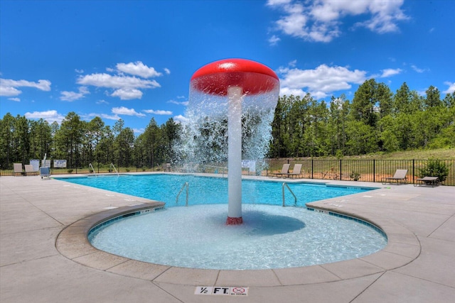 pool featuring fence and a patio