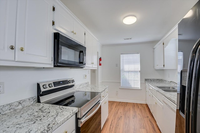 kitchen with white cabinets, light wood-type flooring, sink, and appliances with stainless steel finishes