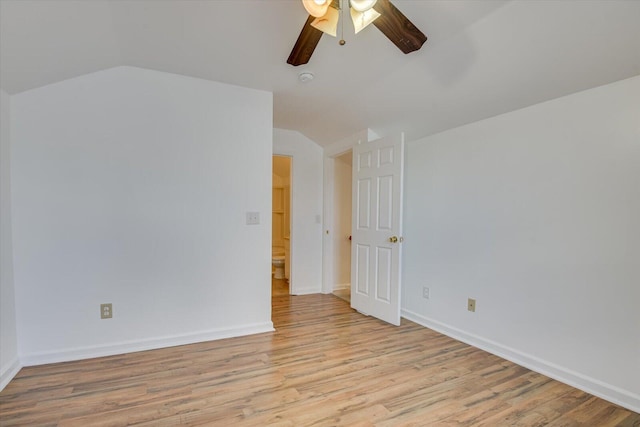 spare room with ceiling fan, light wood-type flooring, and lofted ceiling