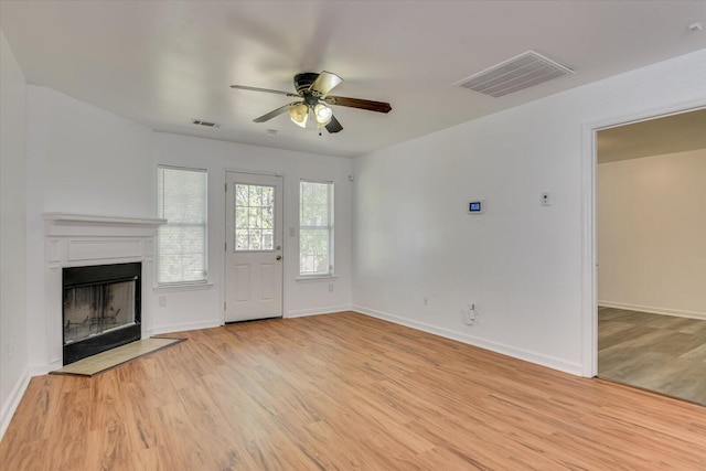 unfurnished living room with ceiling fan and light hardwood / wood-style floors