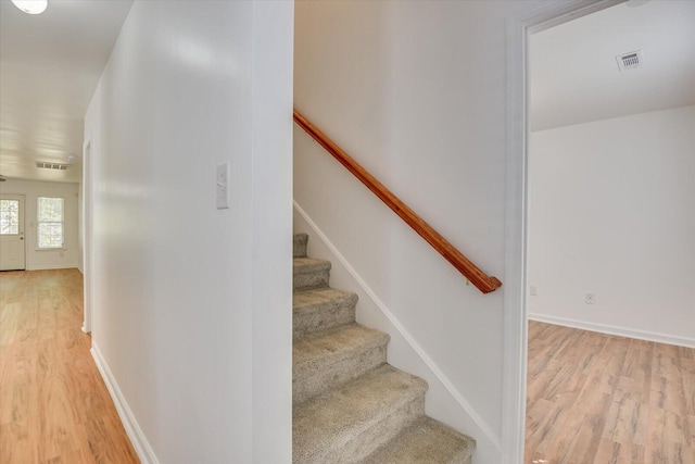 stairs with hardwood / wood-style flooring