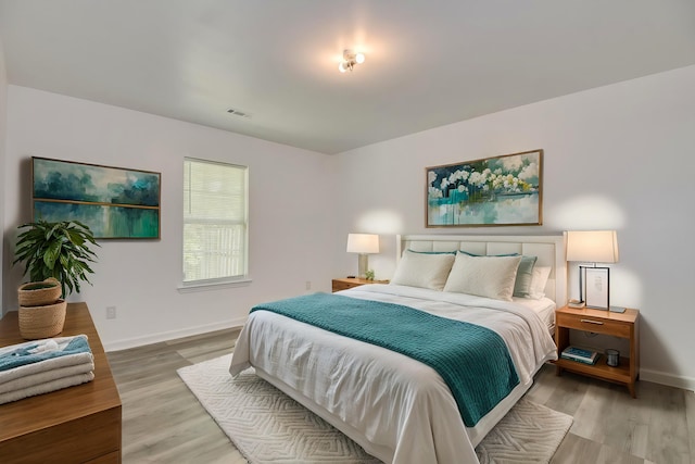 bedroom with hardwood / wood-style flooring