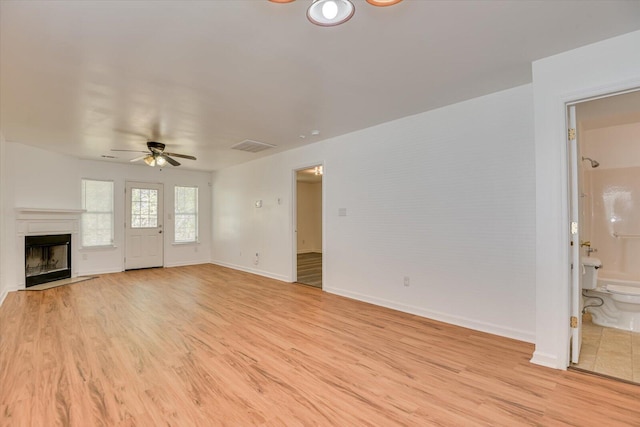 unfurnished living room with light hardwood / wood-style flooring and ceiling fan