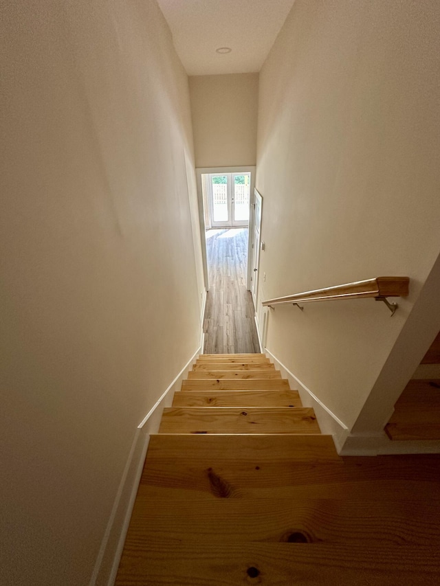 stairs with baseboards and wood finished floors