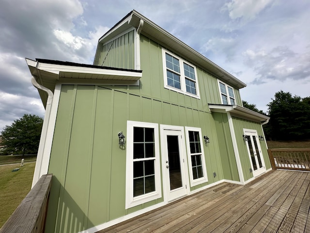 exterior space featuring board and batten siding, french doors, and a deck