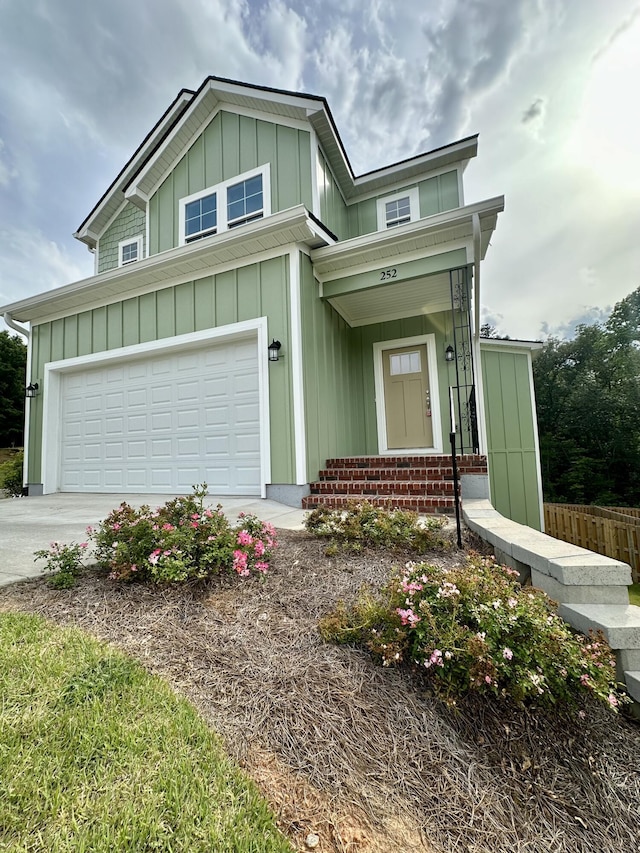 view of front of home with board and batten siding, concrete driveway, and a garage