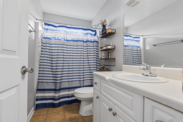 bathroom with a shower with curtain, vanity, toilet, and tile patterned flooring