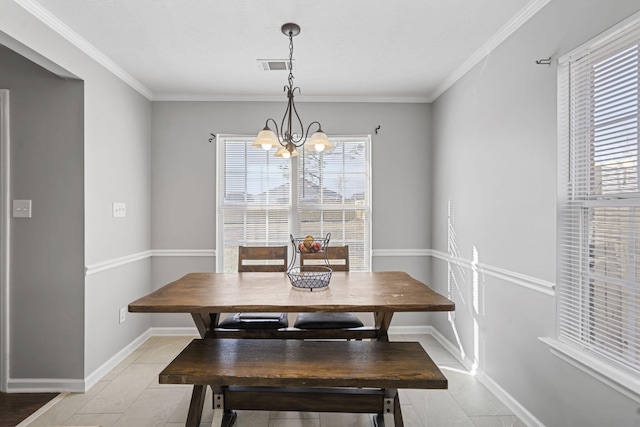 tiled dining room with ornamental molding and a notable chandelier