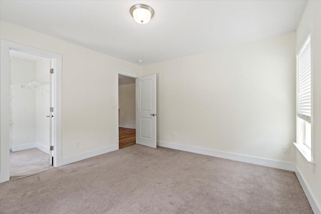 1404 Feldspar Ct, Augusta, GA 30909 - unfurnished bedroom with light colored carpet, a walk in closet, and a closet