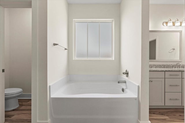 1404 Feldspar Ct, Augusta, GA 30909 - bathroom featuring vanity, wood finished floors, and a garden tub