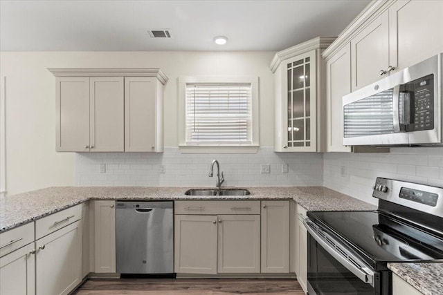 1404 Feldspar Ct, Augusta, GA 30909 - kitchen featuring appliances with stainless steel finishes, wood finished floors, and decorative backsplash