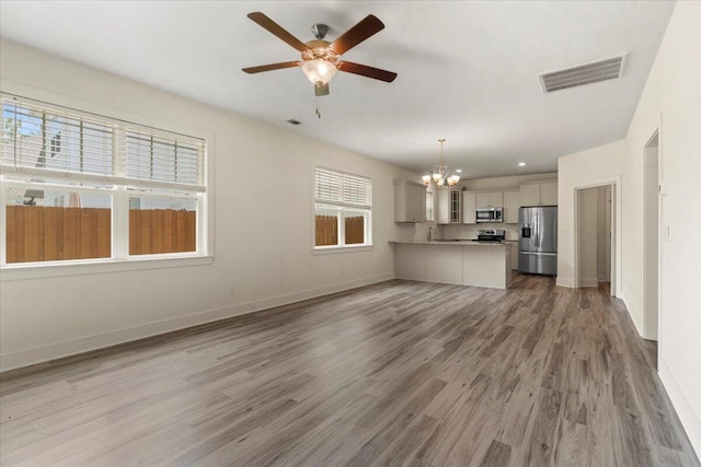 1404 Feldspar Ct, Augusta, GA 30909 - unfurnished living room featuring a chandelier, ceiling fan, light wood finished floors, and recessed lighting