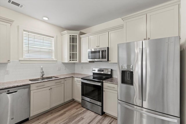 1404 Feldspar Ct, Augusta, GA 30909 - kitchen featuring stainless steel appliances, light stone counters, tasteful backsplash, and recessed lighting