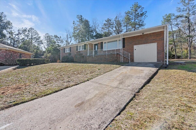 ranch-style home with a garage and a front lawn