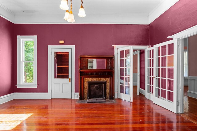 223 E Robert Toombs Ave, Washington, GA 30673 - unfurnished living room featuring a chandelier, wood finished floors, crown molding, a fireplace with flush hearth, and baseboards