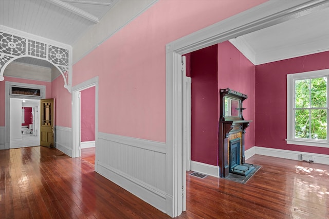 223 E Robert Toombs Ave, Washington, GA 30673 - unfurnished living room with hardwood / wood-style flooring, wainscoting, arched walkways, and ornamental molding