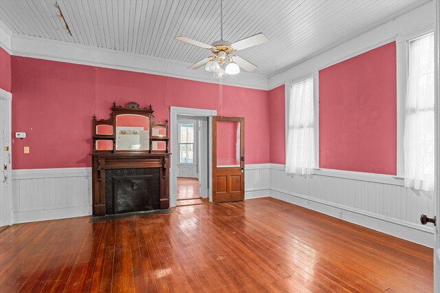 223 E Robert Toombs Ave, Washington, GA 30673 - unfurnished living room featuring hardwood / wood-style floors, a wainscoted wall, ceiling fan, and a premium fireplace