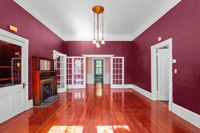 223 E Robert Toombs Ave, Washington, GA 30673 - unfurnished living room with hardwood / wood-style flooring, french doors, a premium fireplace, and crown molding