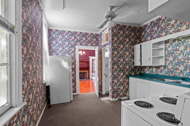 223 E Robert Toombs Ave, Washington, GA 30673 - kitchen with white appliances, a ceiling fan, ornamental molding, white cabinets, and carpet