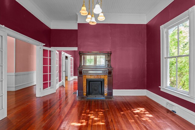 223 E Robert Toombs Ave, Washington, GA 30673 - unfurnished living room with hardwood / wood-style flooring, a chandelier, crown molding, and a tile fireplace