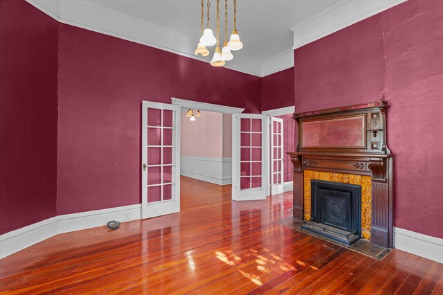 223 E Robert Toombs Ave, Washington, GA 30673 - unfurnished living room with a chandelier, hardwood / wood-style floors, french doors, a premium fireplace, and crown molding