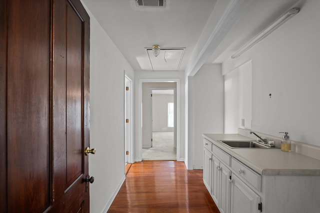 223 E Robert Toombs Ave, Washington, GA 30673 - corridor with a sink, attic access, wood finished floors, and baseboards