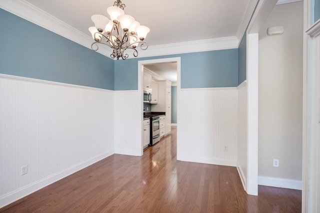 1102 Highmoor Ln, Evans, GA 30809 - unfurnished dining area with dark wood-style flooring, a wainscoted wall, a chandelier, crown molding, and baseboards