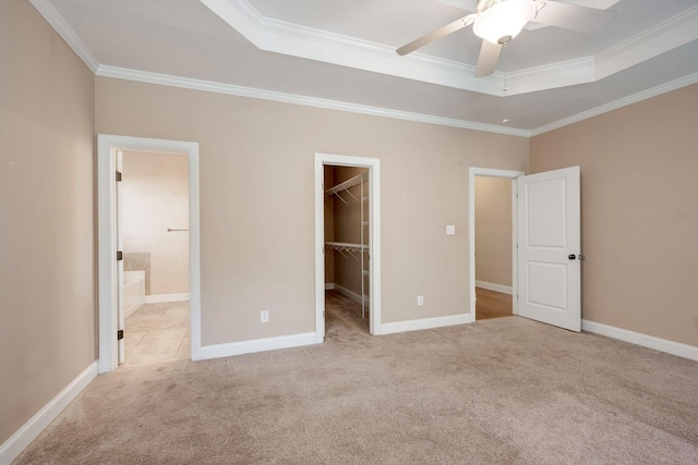 1102 Highmoor Ln, Evans, GA 30809 - unfurnished bedroom featuring a tray ceiling, a walk in closet, carpet flooring, crown molding, and a closet