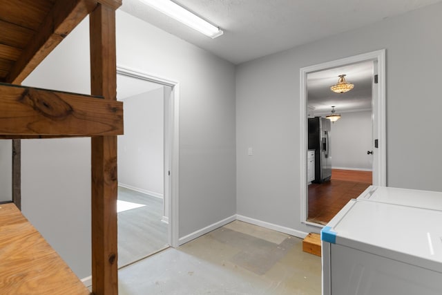3413 Sutton Pl, Augusta, GA 30906 - hallway featuring washing machine and dryer, baseboards, and concrete floors