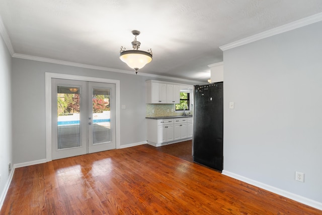 3413 Sutton Pl, Augusta, GA 30906 - kitchen featuring french doors, dark wood-type flooring, freestanding refrigerator, baseboards, and white cabinetry