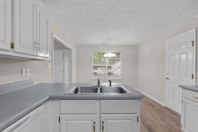 159 Redbud Dr, North Augusta, SC 29841 - kitchen featuring dishwasher, wood finished floors, white cabinetry, decorative light fixtures, and a textured ceiling