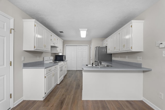 159 Redbud Dr, North Augusta, SC 29841 - kitchen featuring appliances with stainless steel finishes, under cabinet range hood, white cabinetry, a peninsula, and dark wood-style floors