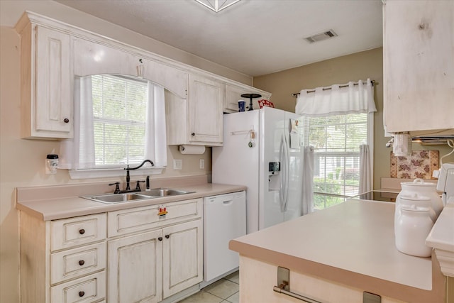 8030 Reagan Cir, Augusta, GA 30909 - kitchen with white appliances, light countertops, and light tile patterned floors