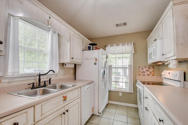 8030 Reagan Cir, Augusta, GA 30909 - kitchen featuring white appliances, healthy amount of natural light, light tile patterned floors, and light countertops