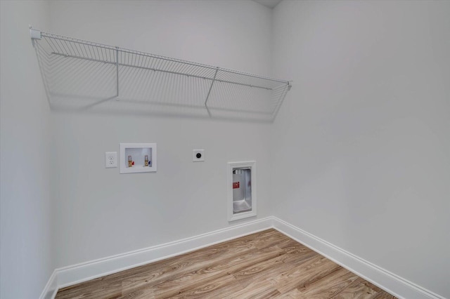 clothes washing area featuring laundry area, baseboards, light wood-style floors, washer hookup, and electric dryer hookup