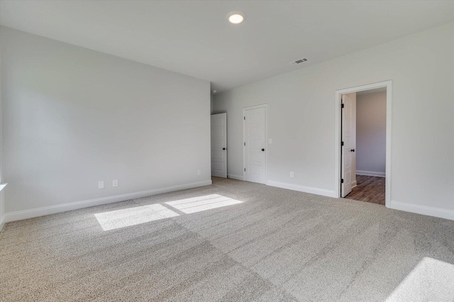 unfurnished bedroom featuring carpet, visible vents, and baseboards