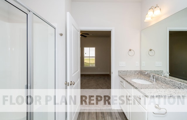 bathroom featuring a shower with door, vanity, hardwood / wood-style floors, and ceiling fan