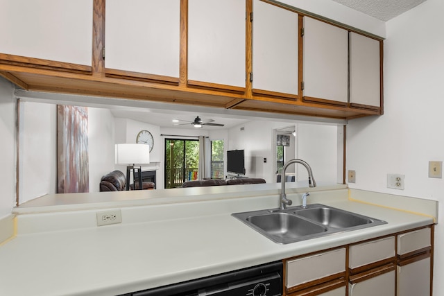 kitchen featuring dishwasher, white cabinetry, ceiling fan, and sink