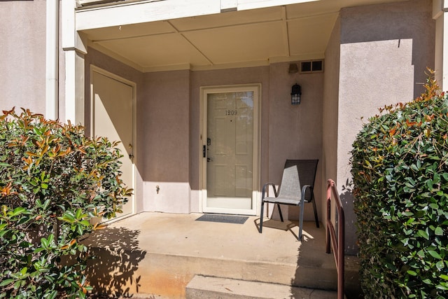 doorway to property with a patio area