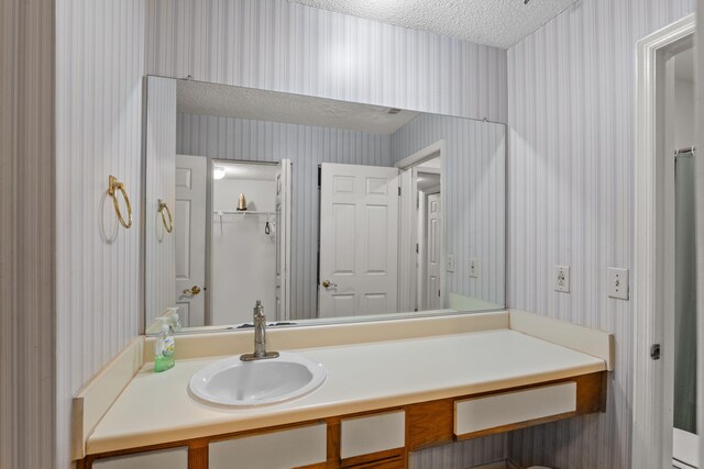 bathroom featuring vanity and a textured ceiling