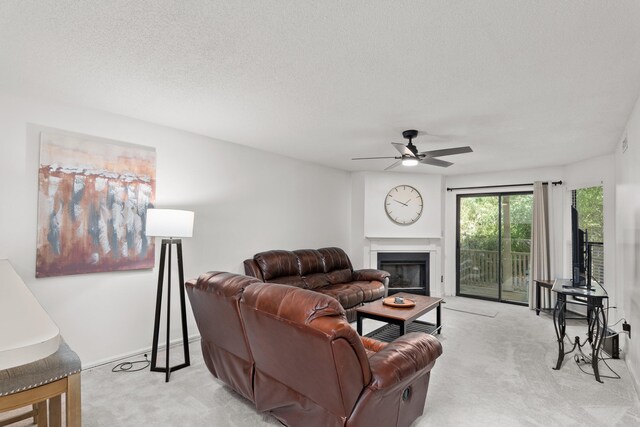 living room with light carpet, a textured ceiling, and ceiling fan