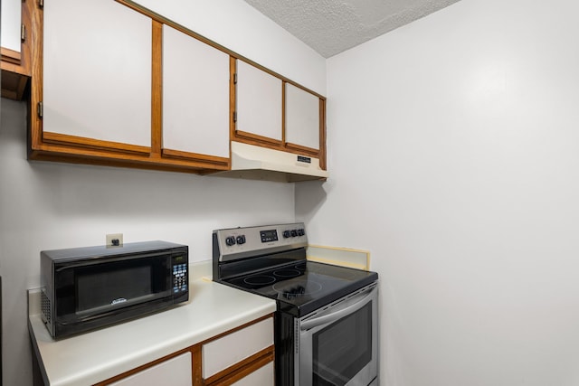 kitchen featuring white cabinetry, stainless steel range with electric cooktop, and a textured ceiling